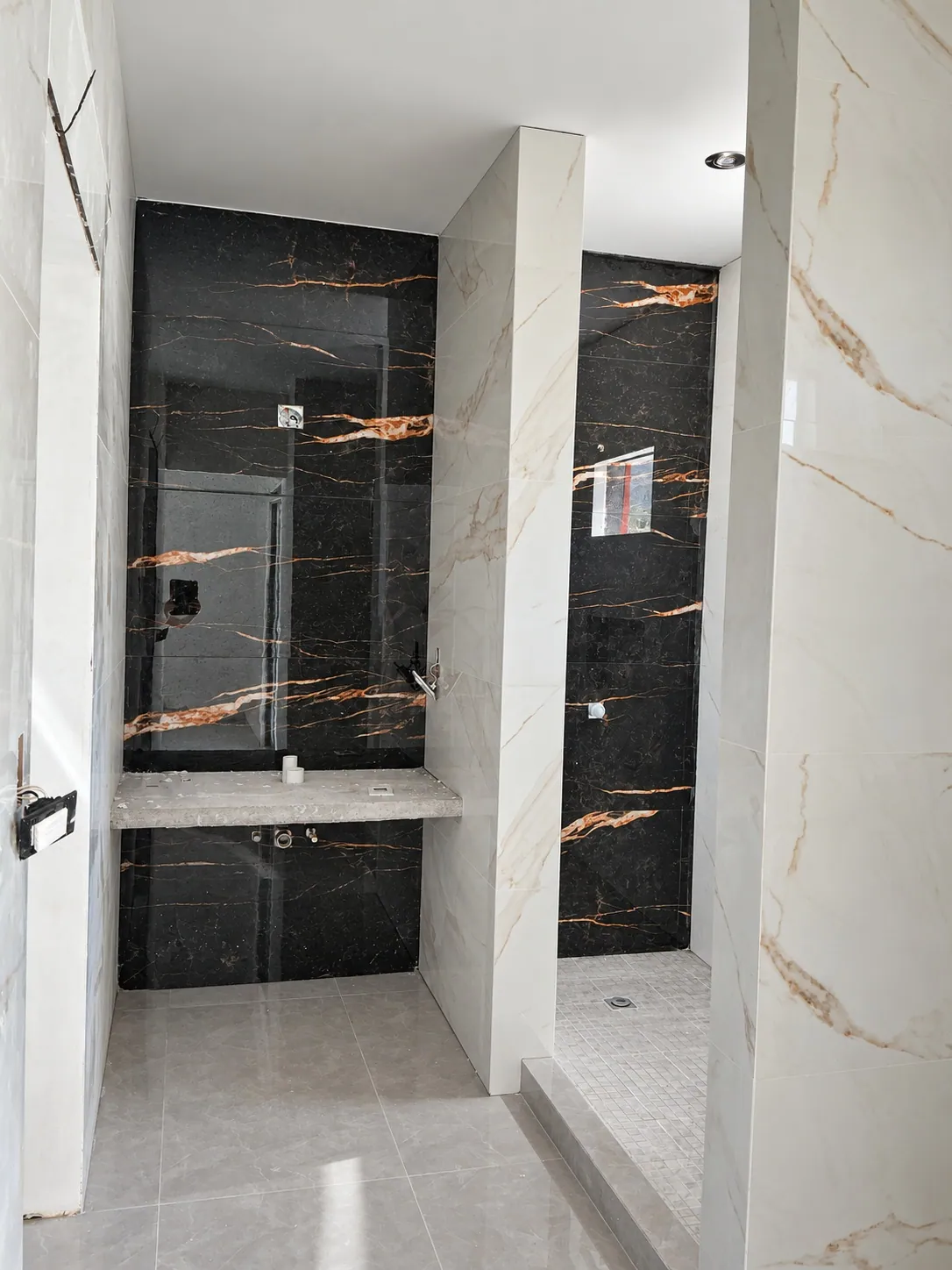 Baño principal con muro de mármol oscuro