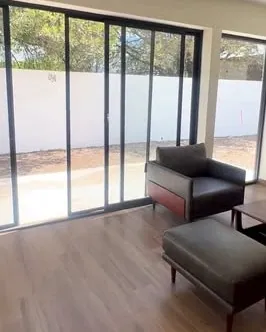 Sala terminada con cancel corredizo hacia el jardín